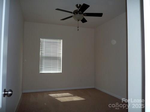 1003 Blue Stream Lane Indian Trail, NC 28079 - Photo 7 of 18 an empty room with a window and a fan