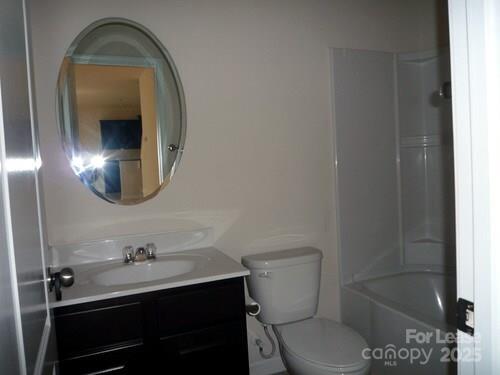 1003 Blue Stream Lane Indian Trail, NC 28079 - Photo 8 of 18 a bathroom with a toilet a sink and mirror