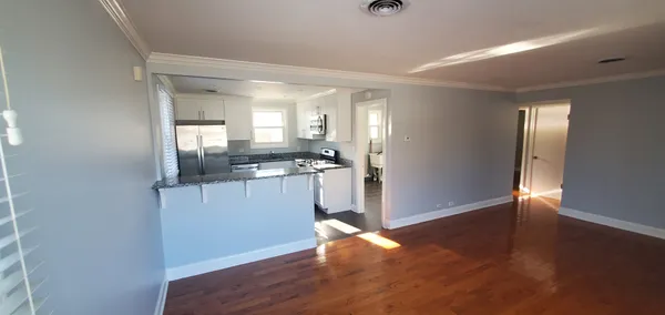 a view of a kitchen cabinets and wooden floor