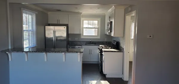a kitchen with a refrigerator and a sink