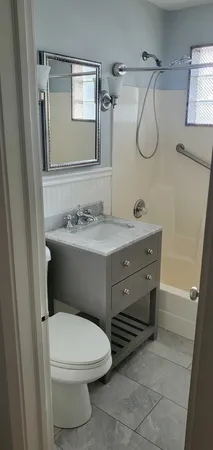 a bathroom with a sink toilet and mirror