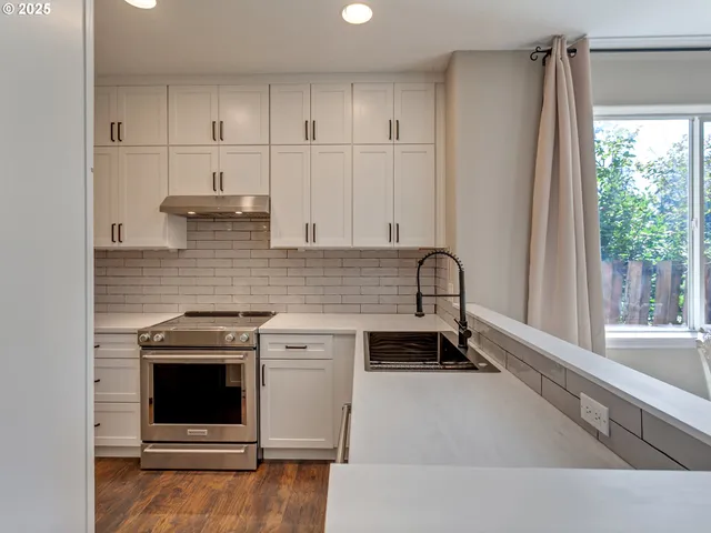 a kitchen with a stove and a refrigerator