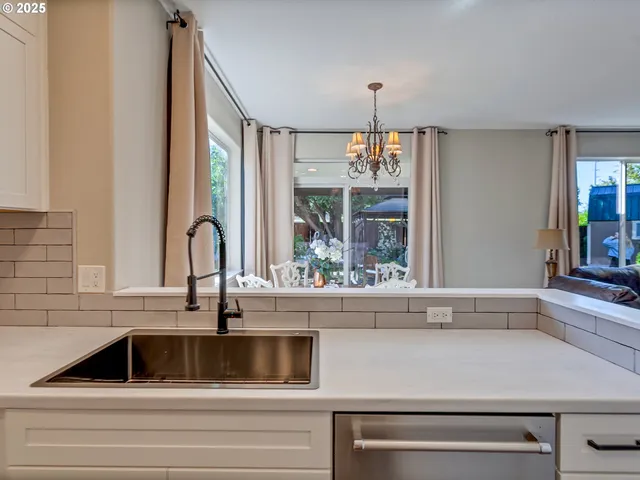 a kitchen with a sink and large window