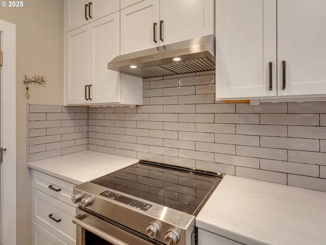a stove top oven sitting inside of a kitchen