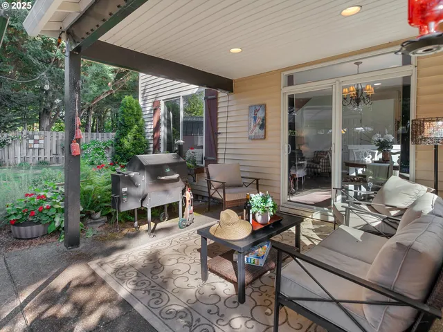 a view of patio with table and chairs under an umbrella