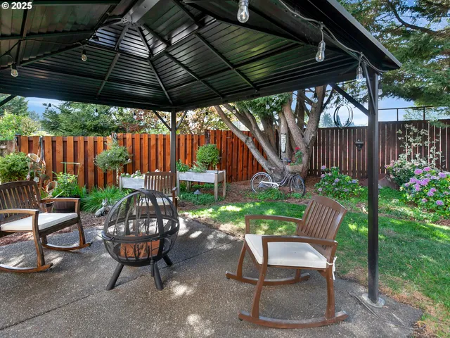 a view of a house with a yard and tree s