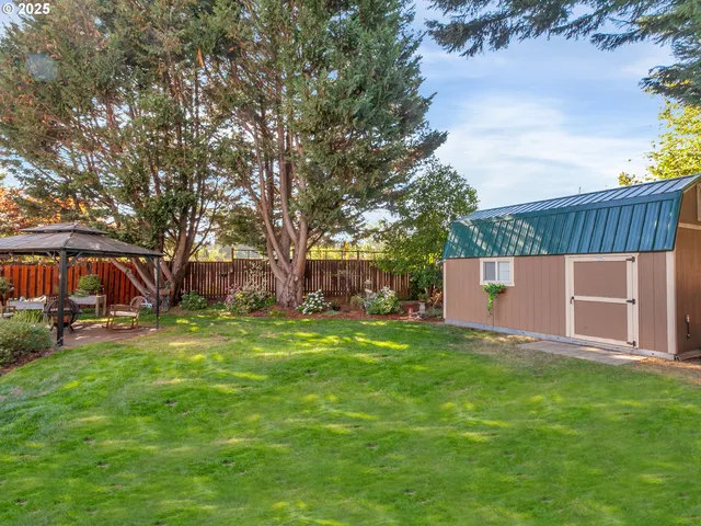 a patio with table and chairs and potted plants