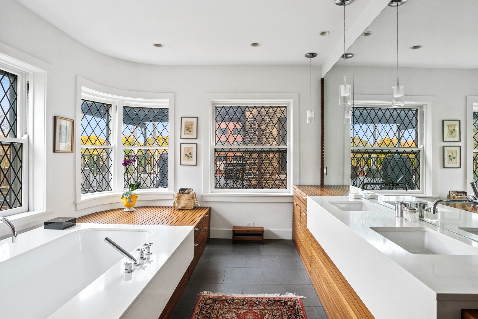 710 West Junior Terrace, Unit 2 Chicago, IL 60613 - Photo 19 of 37 a bathroom with a tub a sink and a large window