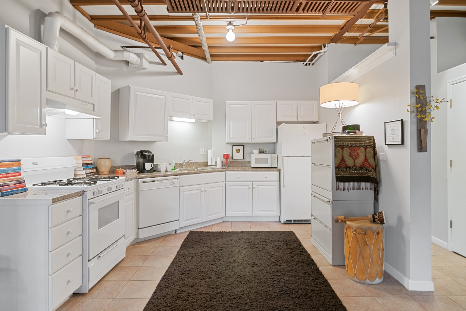 710 West Junior Terrace, Unit 2 Chicago, IL 60613 - Photo 35 of 37 a kitchen with white cabinets and white appliances