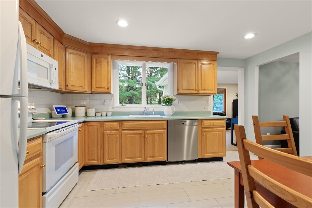 33 Longmeadow Lane Sharon, MA 02067 - Photo 11 of 29 a kitchen with granite countertop a stove top oven sink and cabinets