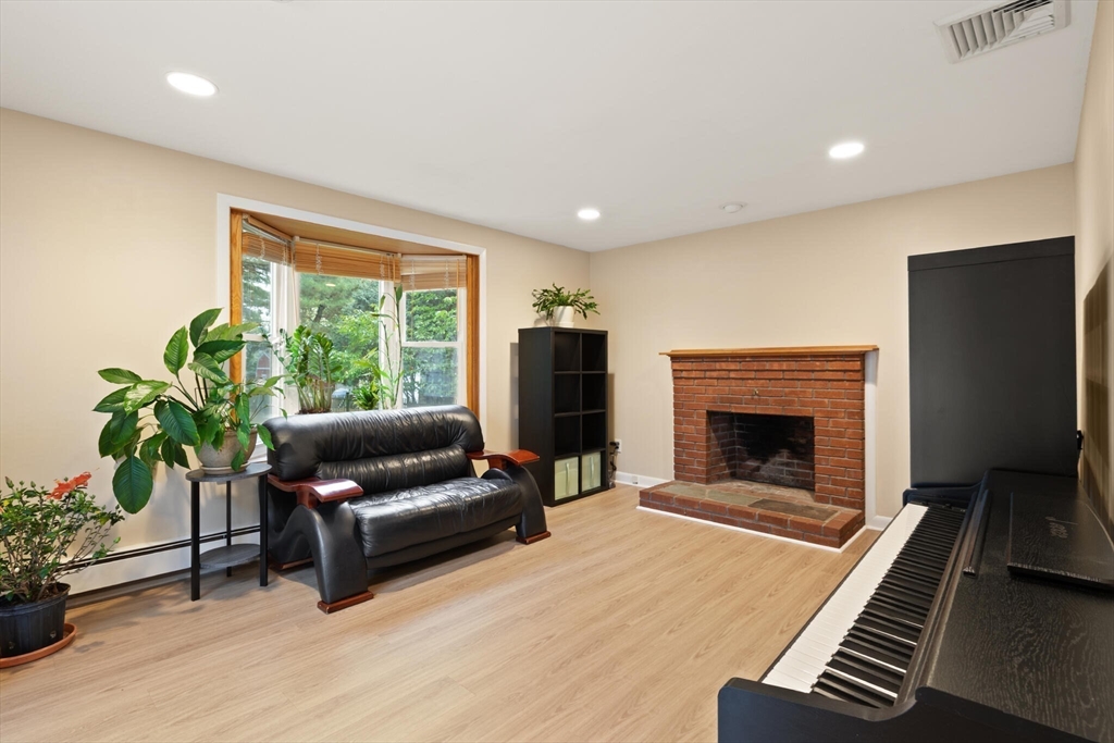 33 Longmeadow Lane Sharon, MA 02067 - Photo 8 of 29 a living room with furniture and a fireplace