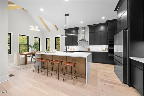 a metallic refrigerator freezer sitting in a kitchen