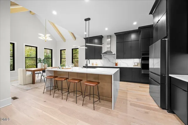 a metallic refrigerator freezer sitting in a kitchen
