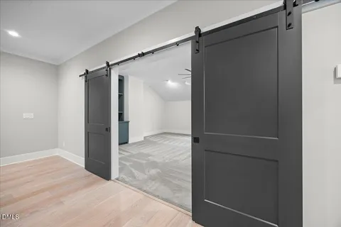 a bathroom with a white tub shower and closet