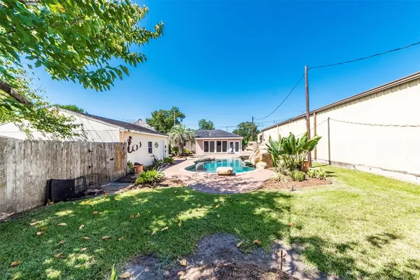 a view of a backyard with plants and a patio