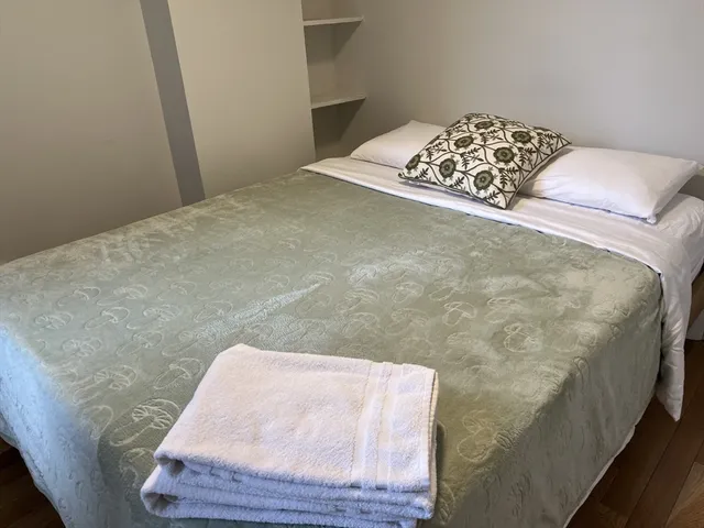 a bedroom with a bed and a chair