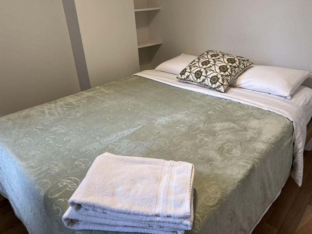 35 Grove Street, Unit 3 Boston, MA 02114 - Photo 14 of 20 a bedroom with a bed and a painting on the wall