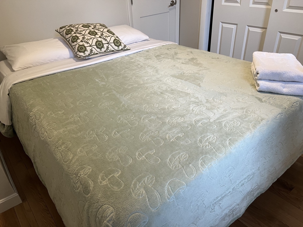 35 Grove Street, Unit 3 Boston, MA 02114 - Photo 15 of 20 a bedroom with a bed and a chair