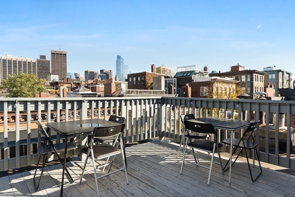 35 Grove Street, Unit 3 Boston, MA 02114 - Photo 17 of 20 a view of a chairs and table on wooden deck