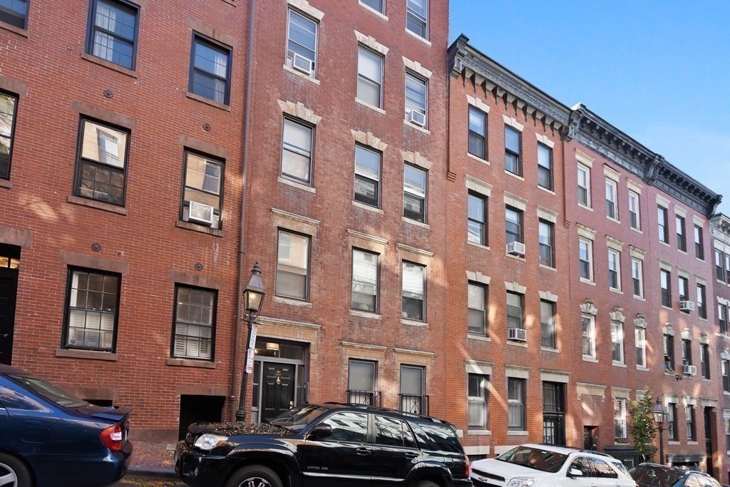 35 Grove Street, Unit 3 Boston, MA 02114 - Photo 20 of 20 a front view of a building with lot of cars parked on city street