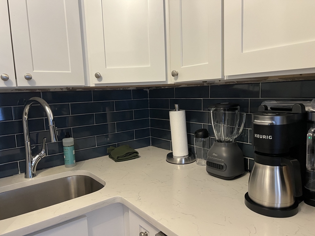 35 Grove Street, Unit 3 Boston, MA 02114 - Photo 3 of 20 a kitchen with a sink and a window