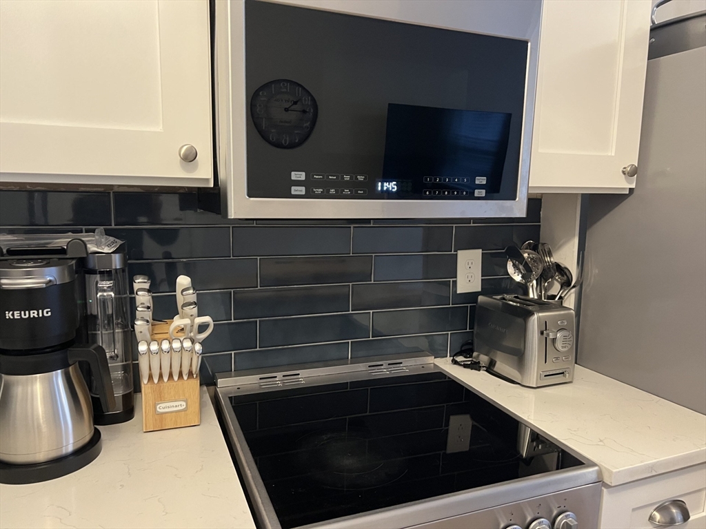 35 Grove Street, Unit 3 Boston, MA 02114 - Photo 4 of 20 a kitchen with a stove and a microwave