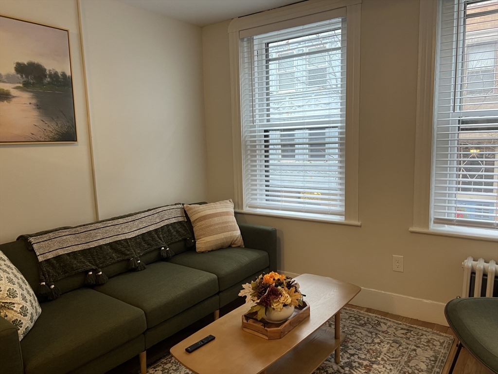 35 Grove Street, Unit 3 Boston, MA 02114 - Photo 7 of 20 a living room with furniture and a window