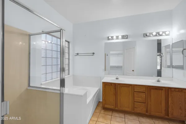 a bathroom with a tub sink and mirror