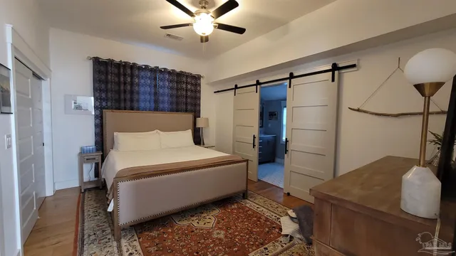 a bedroom with a bed and a chandelier
