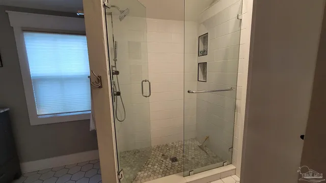 a bathroom with a glass shower door