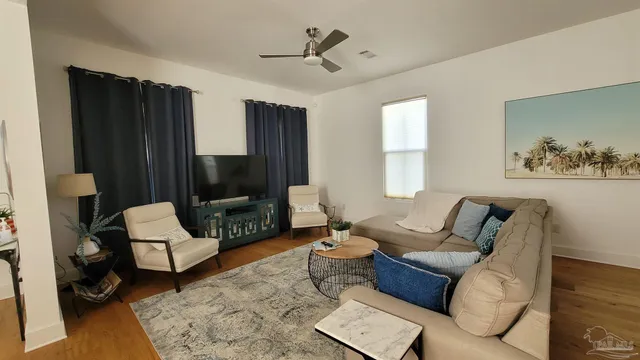 a living room with furniture and a flat screen tv