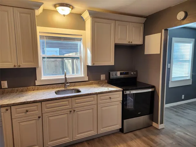 a kitchen with granite countertop cabinets and window