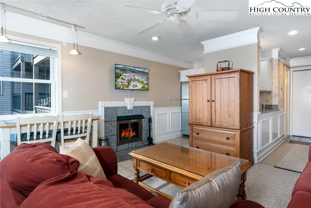 a living room with furniture fireplace and flat screen tv