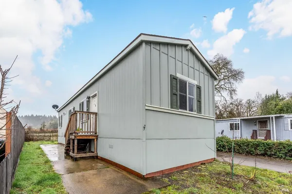 a view of backyard of house and car parked