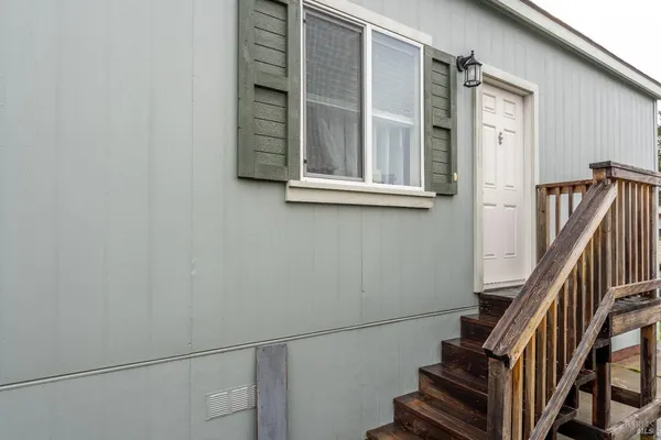 a view of staircase with wooden floor and white walls