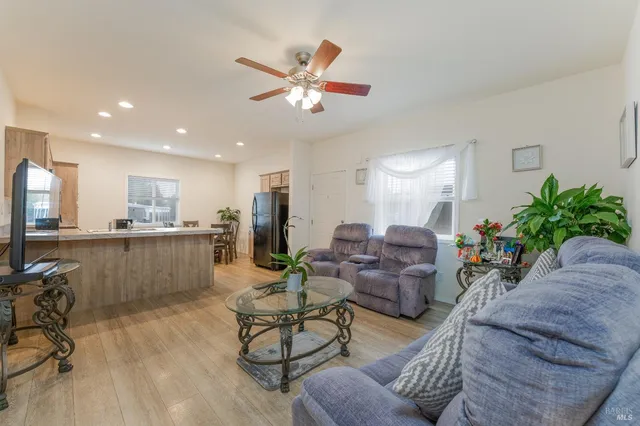 a living room with furniture and kitchen view