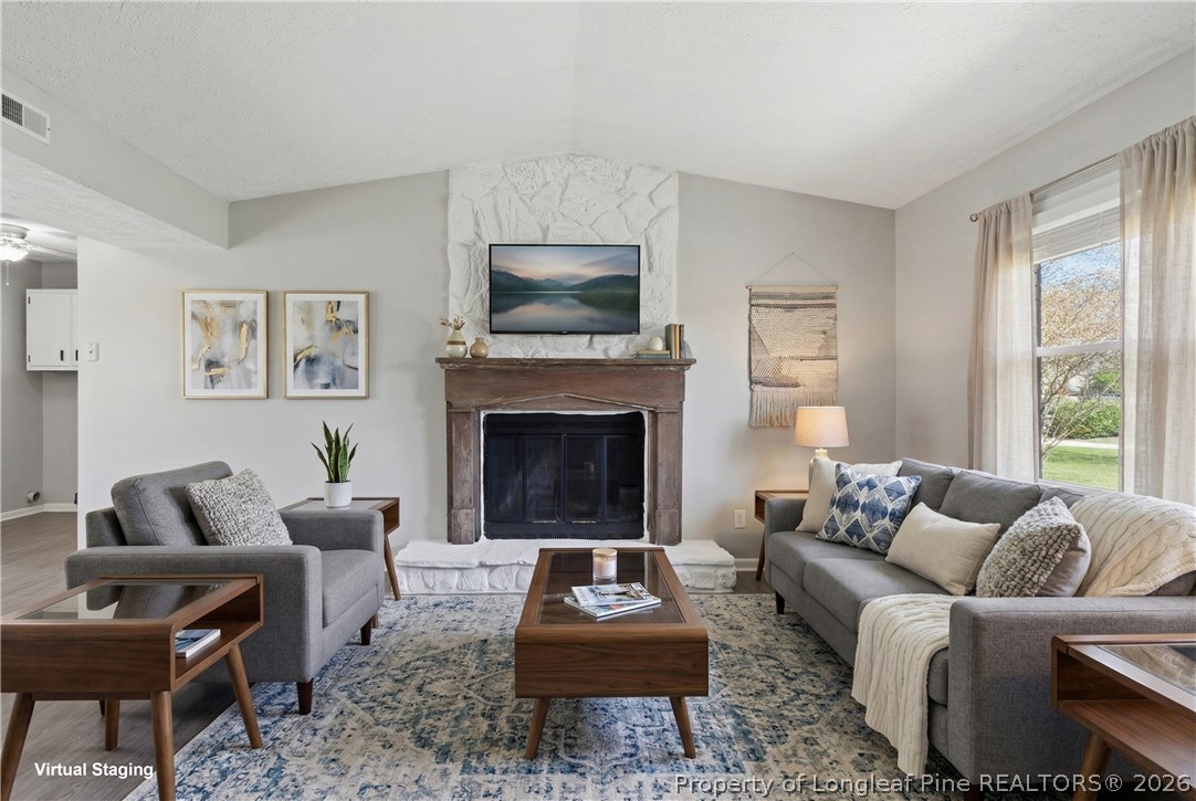 6319 Rustic Ridge Hope Mills, NC 28348 - Photo 6 of 39 a living room with furniture a rug a window and a fireplace