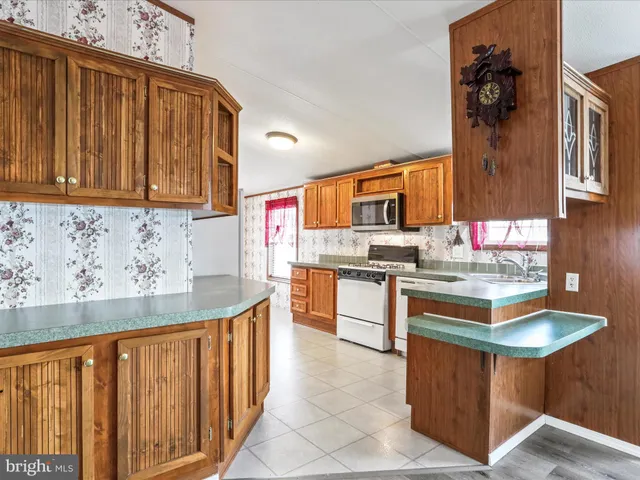 a kitchen with granite countertop a sink and cabinets