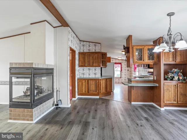 a kitchen with granite countertop wooden floors and wide window