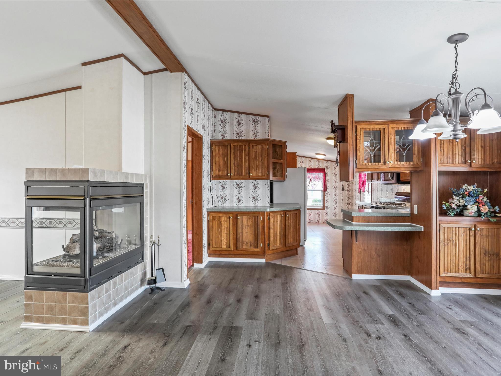 16810 Alcott Road Hagerstown, MD 21740 - Photo 13 of 34 a kitchen with granite countertop wooden floors and wide window