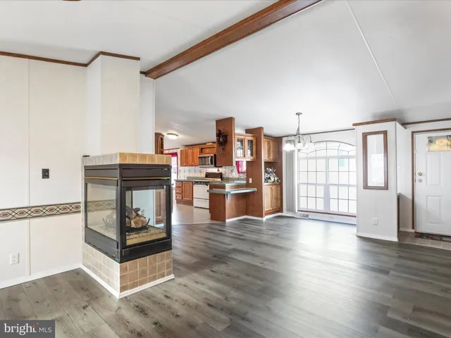 a living room with furniture and wooden floors