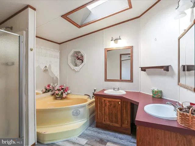 a bathroom with a tub sink and mirror