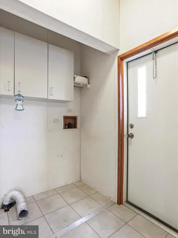 a view of a utility room with cabinets