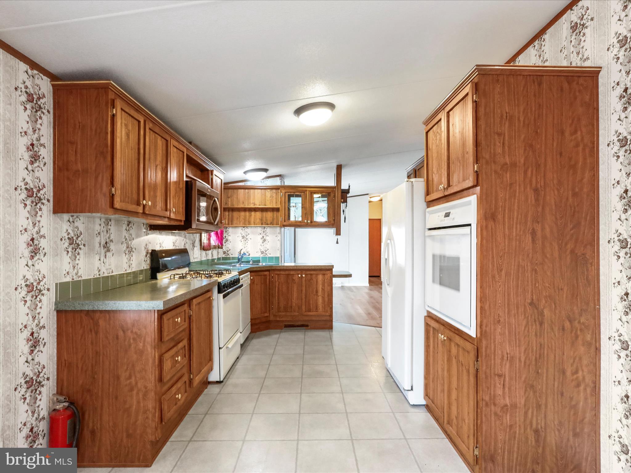 16810 Alcott Road Hagerstown, MD 21740 - Photo 7 of 34 a large kitchen with stainless steel appliances granite countertop a stove a sink dishwasher and a refrigerator