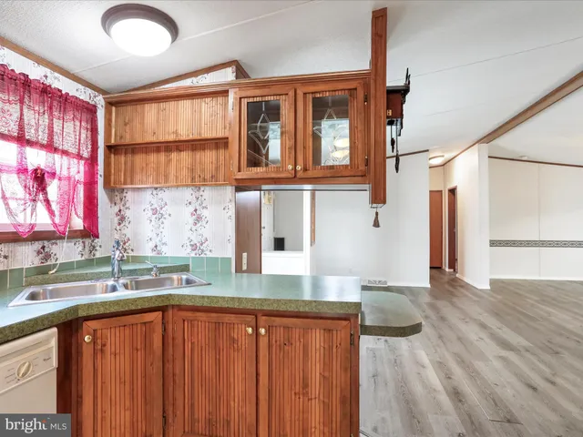 a kitchen with stainless steel appliances granite countertop a sink and a granite counter tops with a large window