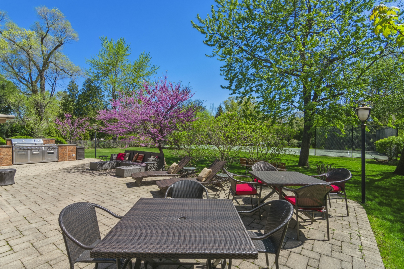 425 Sunset Ridge Road Northfield, IL 60093 - Photo 29 of 53 a view of a patio with table and chairs potted plants and a palm tree