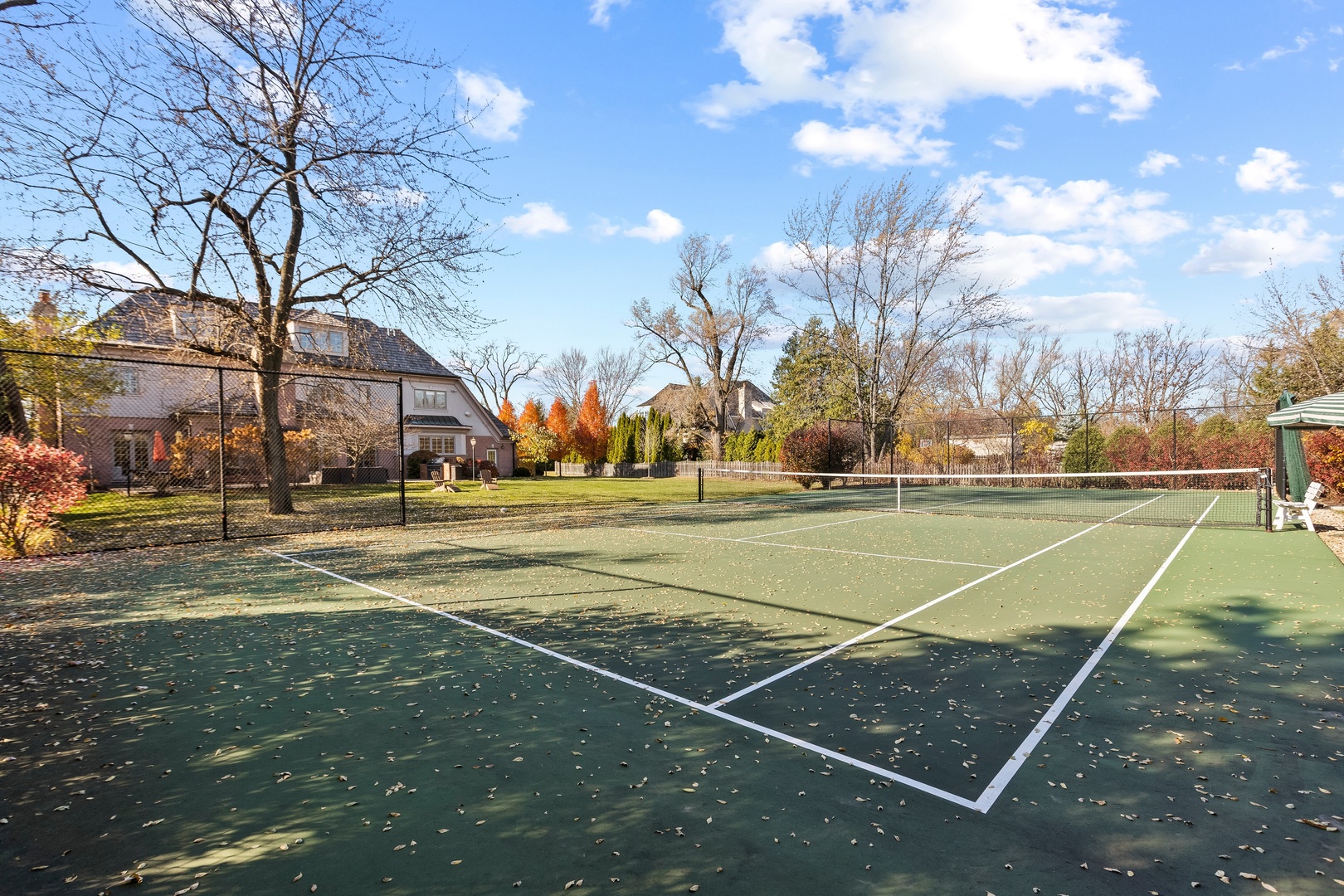 425 Sunset Ridge Road Northfield, IL 60093 - Photo 37 of 53 a view of a tennis ground with large trees