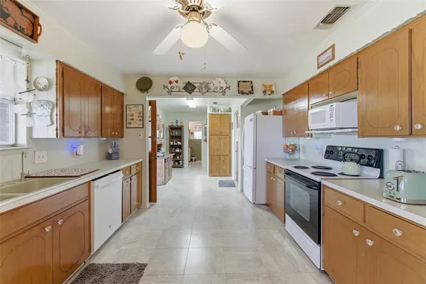 a large kitchen with stainless steel appliances lots of counter space and a sink