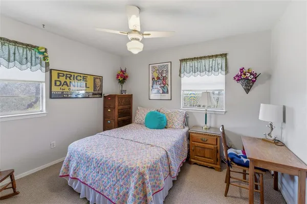 a bedroom with a bed a couch and dresser