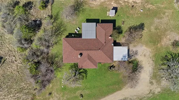 an aerial view of a house with a yard